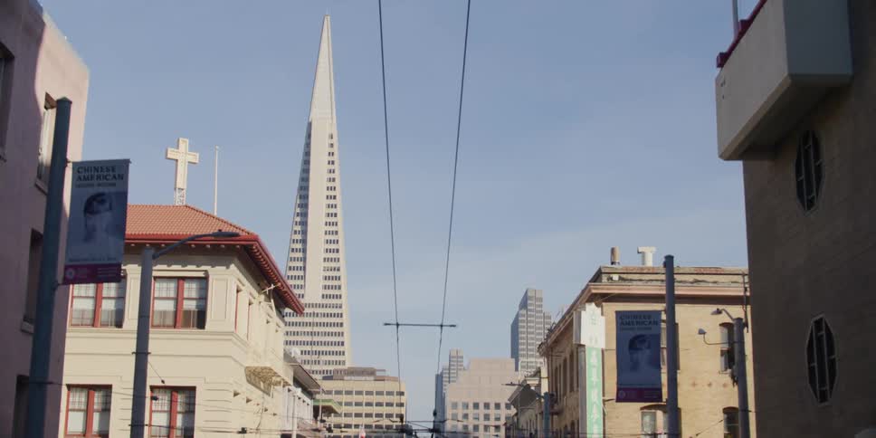 Power lines run above a city street leading to downtown