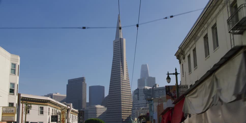 Driving on a street in san francisco towards the transamerica pyramid at morning