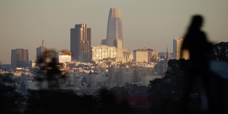 A city skyline seen from passing cars on an elevated road