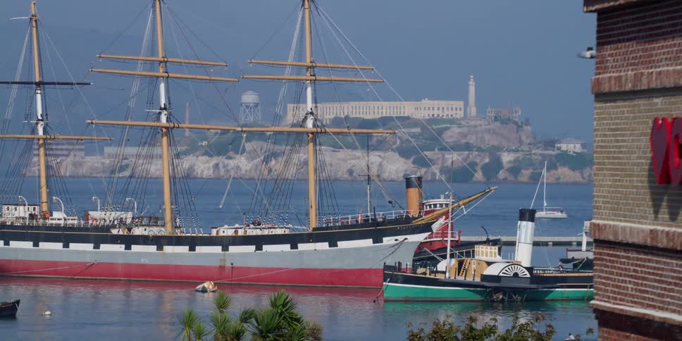 Sailing ship and other vessels float near cvs store sitting near shore