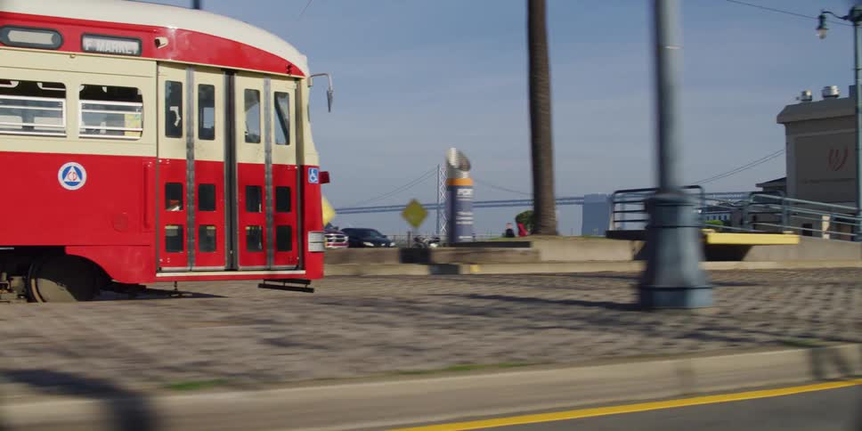 A bus is moving through a city during the daytime