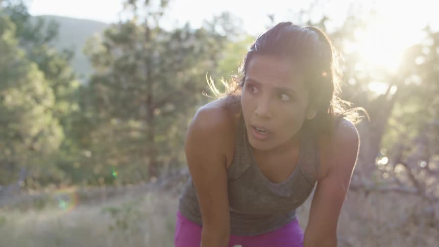 A woman stops running to take a rest before going on