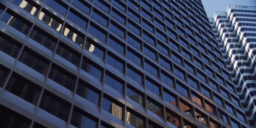 Glass of windows on skyscrapers reflect other buildings