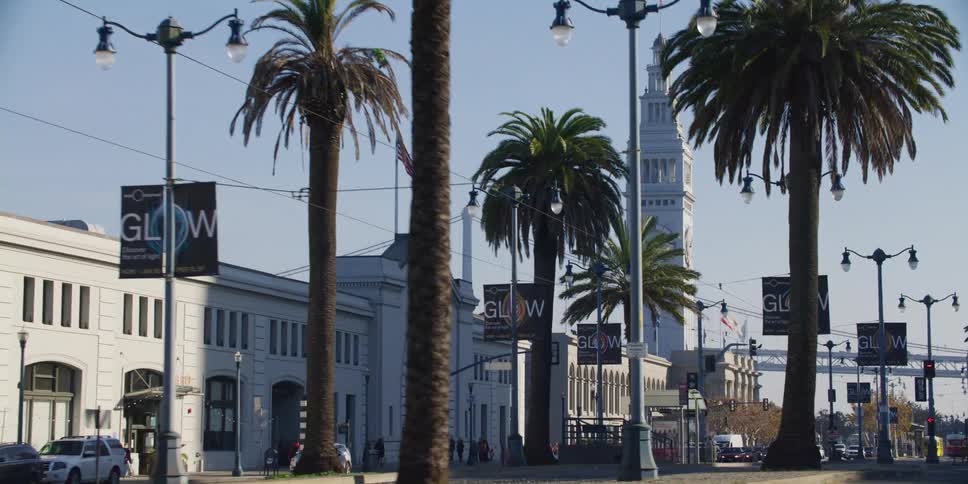 People and cars going down a city street