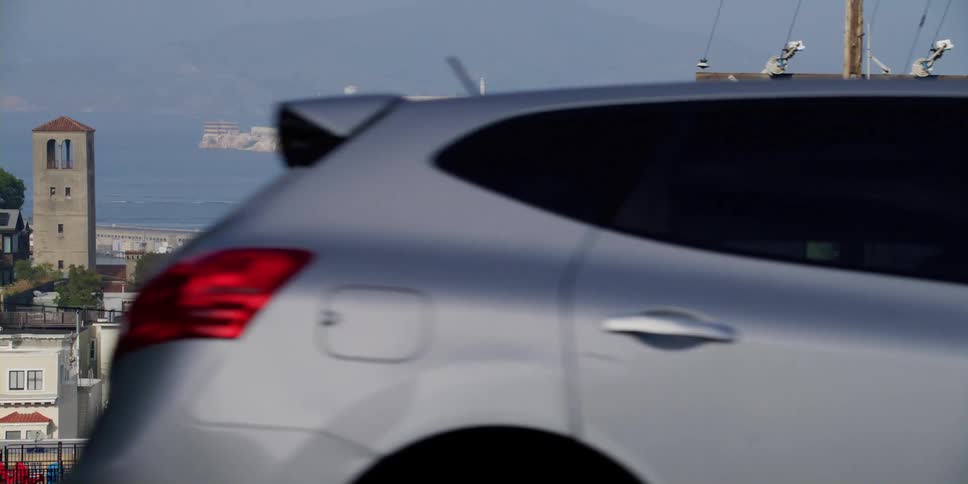 Cars are driving through a city during spring