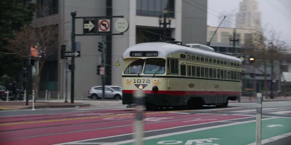 A bus style trolley drives through downtown