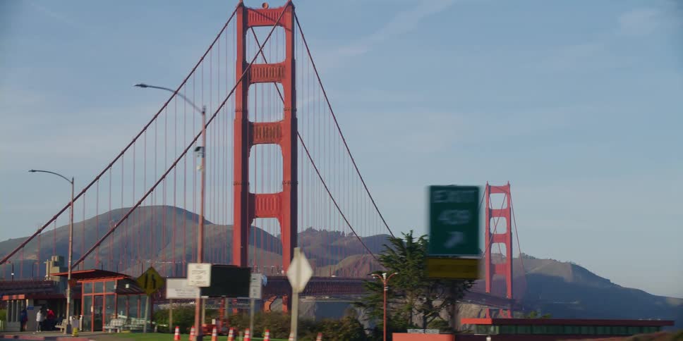 Vehicles travel over the large red bridge