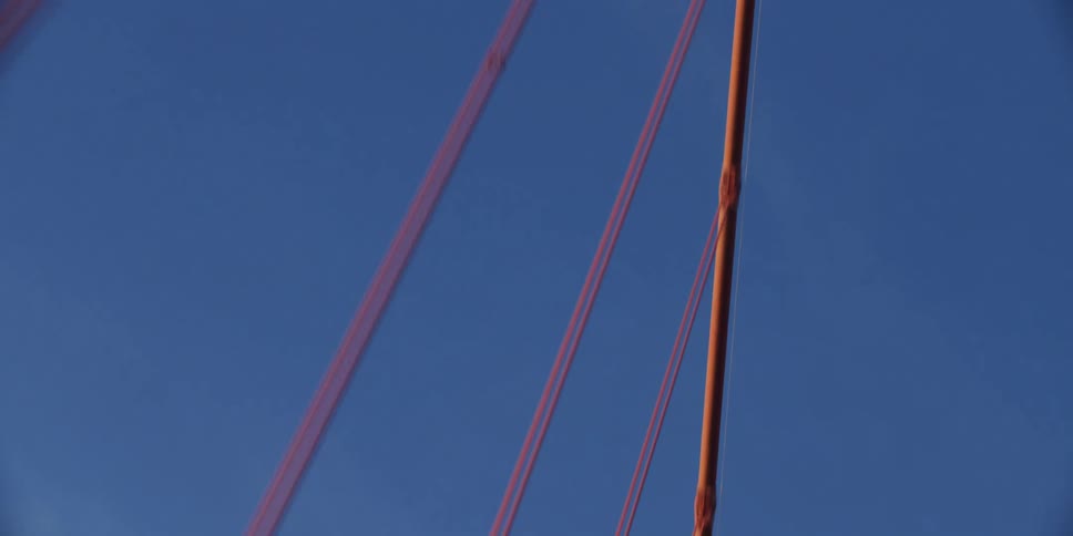 Suspension bridge with suspension cables on vertical suspenders