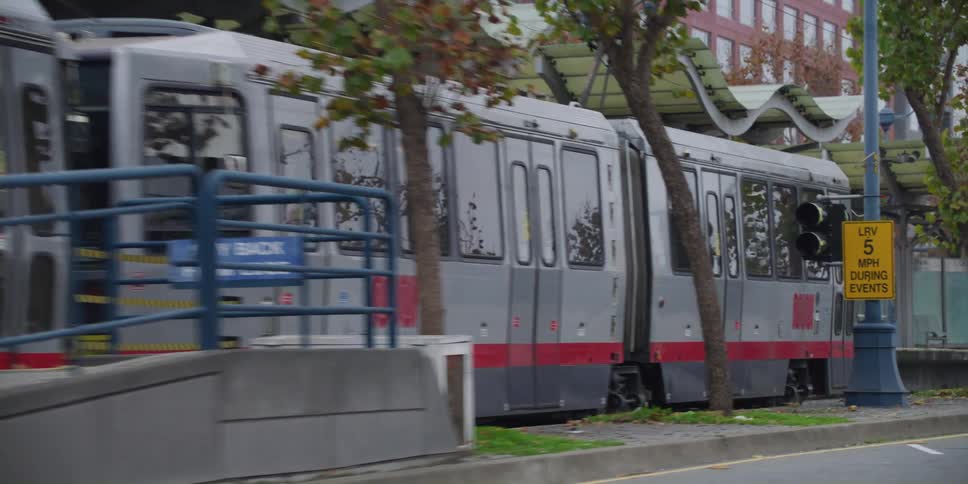 A commuter train is stopped at a depot downtown