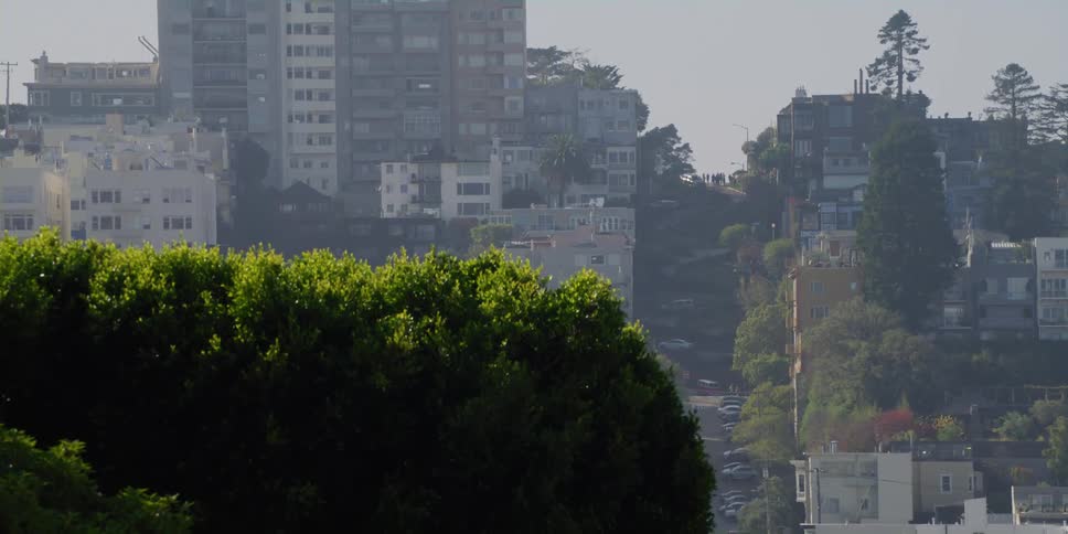 Apartment buildings in a city sit along a steep hill