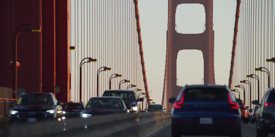Vehicles drive in traffic across the bridge