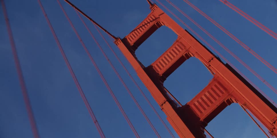 View of the upper part of a suspension bridge looking up at the cables
