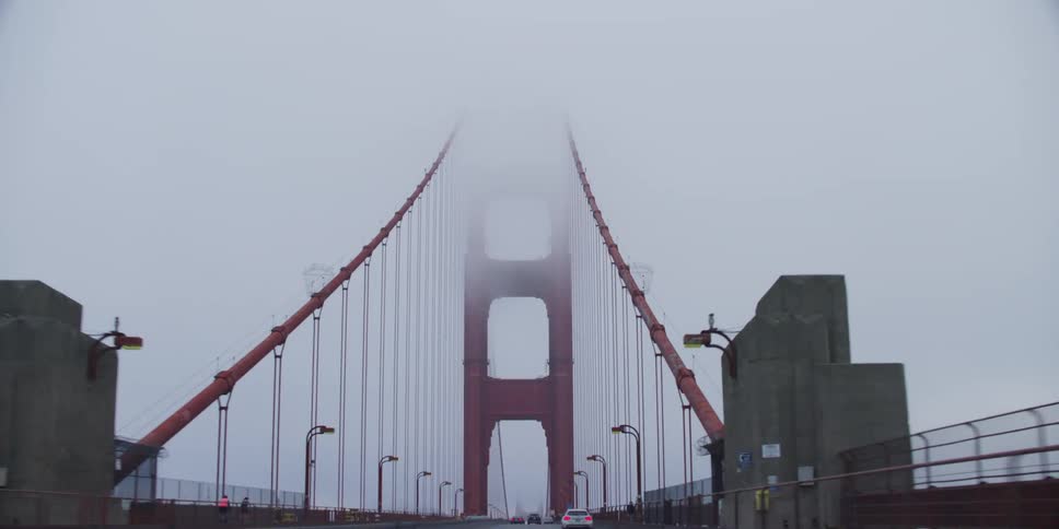 Driving across the golden gate bridges highway on a cloud day