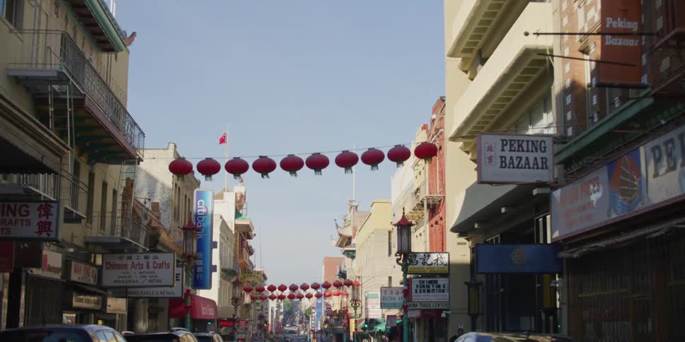 Big citys street with multiple cars and buildings in a chinese neighborhood