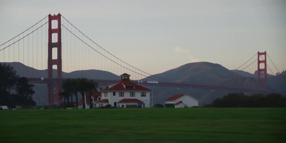 The green field leads to a large bridge