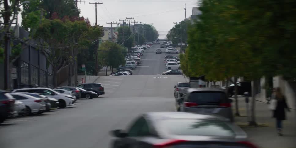 Cars are driving on roads in a city during the daytime