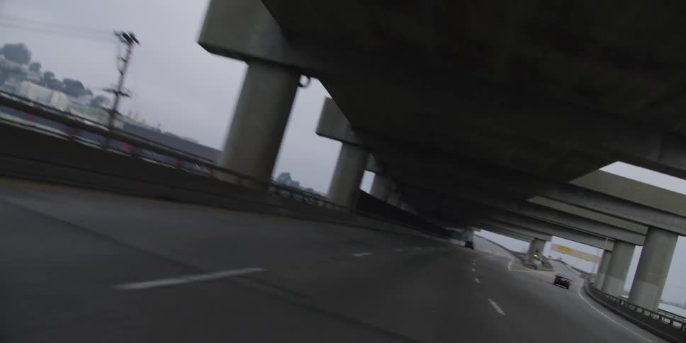 Vehicles are driving on a bridge over the water