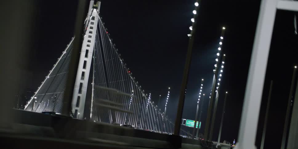 Driving towards a big suspension bridge at night