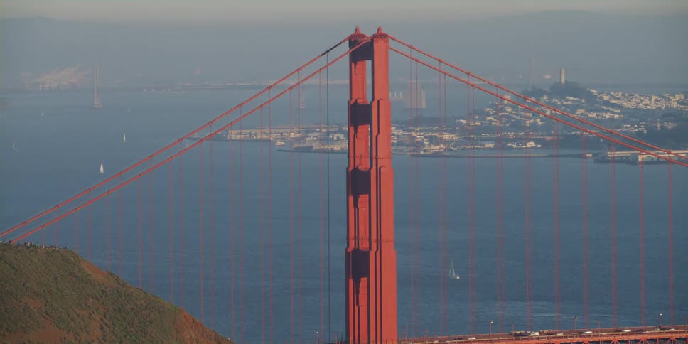 Cars drive on the bridge by the city