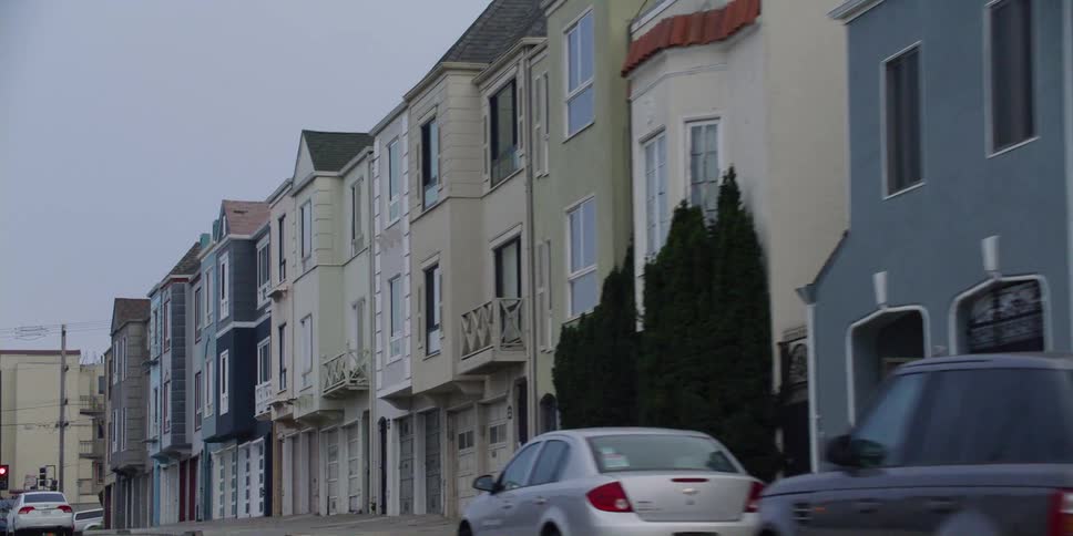 A view of terraced houses seen from a moving car in street