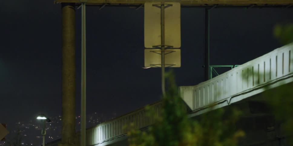 Crescent moon rising over the highway in the city at night