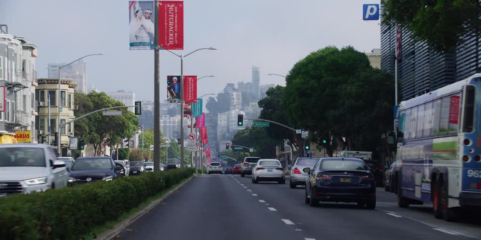 Cars driving in a busy street at the middle of a big city