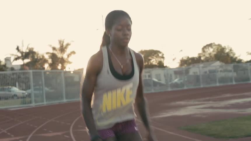 A female athlete warms up on the track
