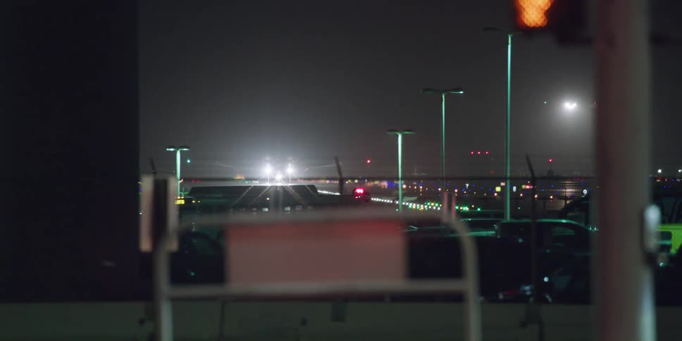Bus driving close to the runway on an airport at night