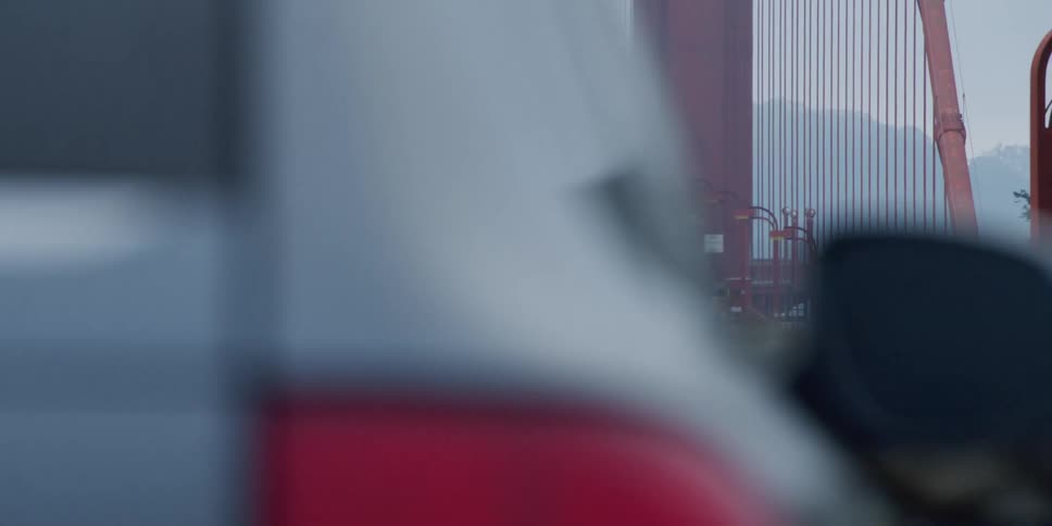 Cars are driving on a bridge during the morning