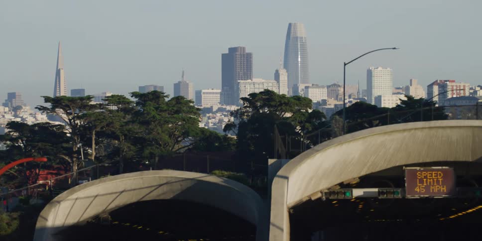 An electronic sign lists the speed limit for a tunnel heading toward downtown
