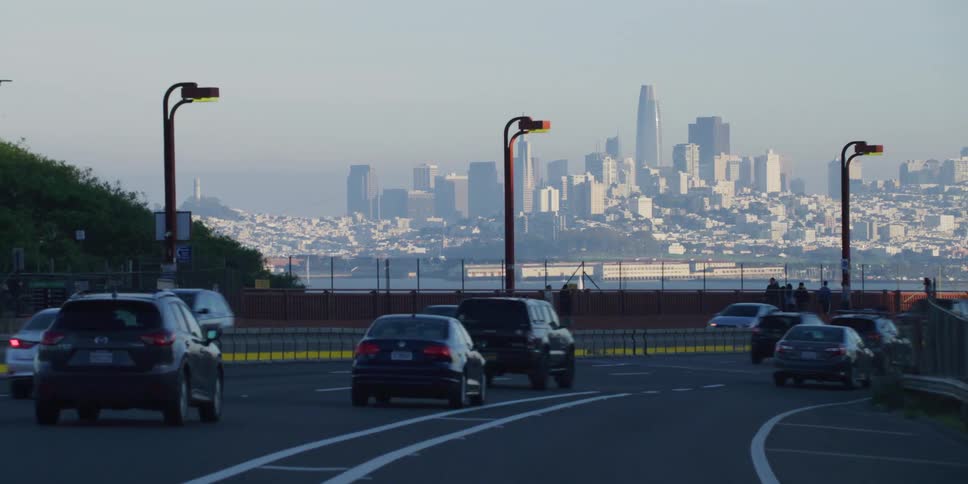 Highway with multiple moving driving cars while manhattans skyline appears in the horizon