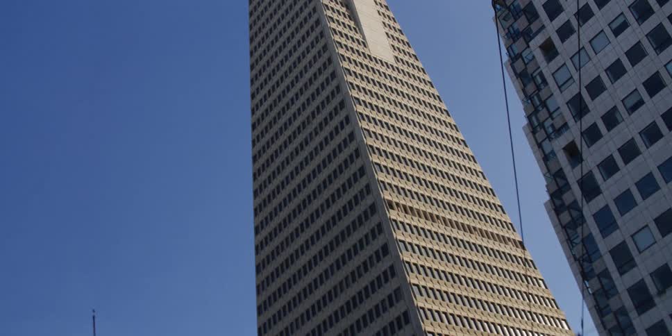 Looking up at tall skyscrapers on a clear day