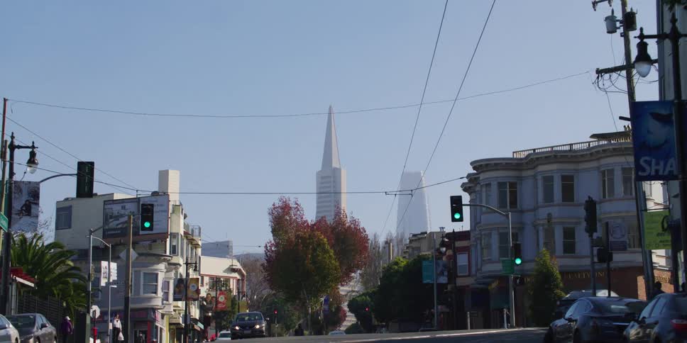 Driving on a street in san francisco towards the transamerica pyramid at morning