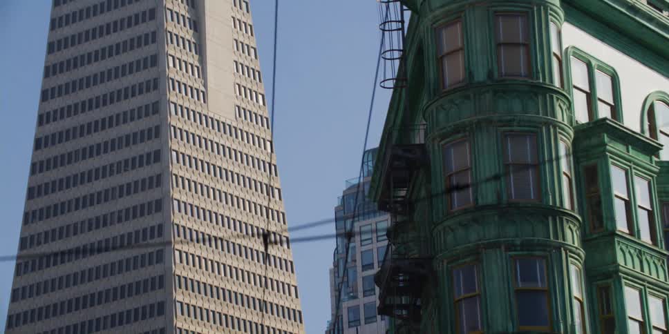 Tower building with high rise buildings against the blue sky in the city
