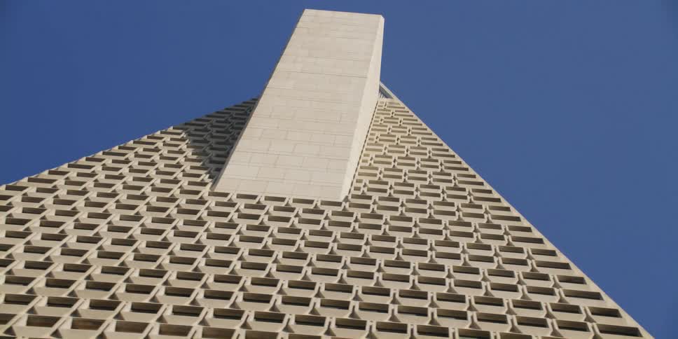 Looking up at the transamerica pyramid building in san francisco against a blue sky