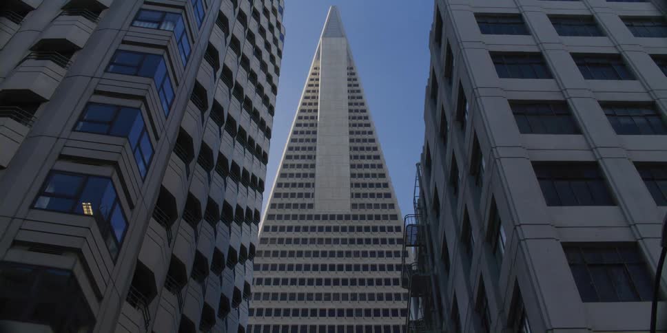 Looking up at tall skyscrapers high in a blue sky
