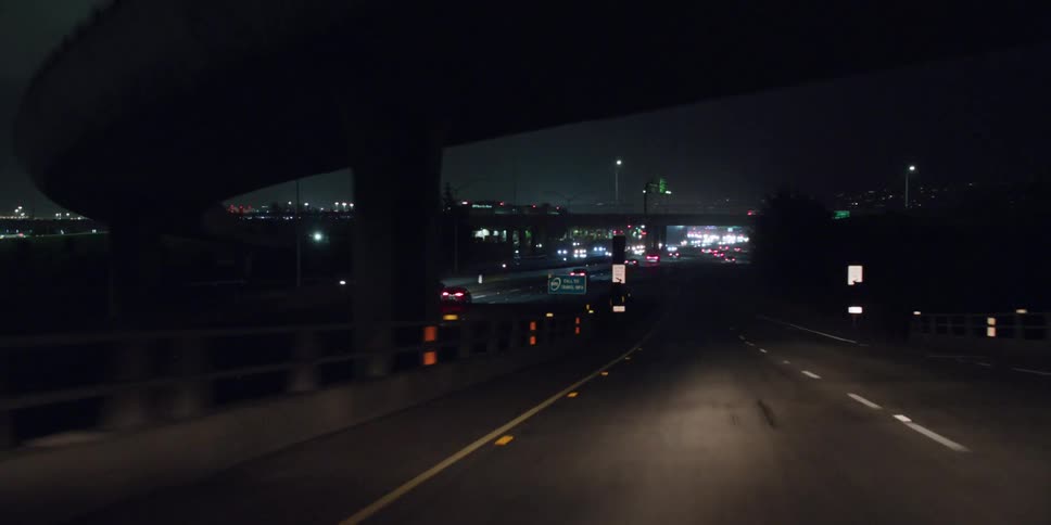 Vehicle illuminating road drives on highway at night
