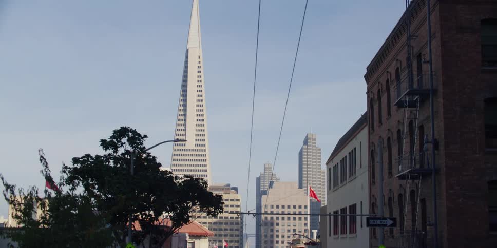 Driving on a street in san francisco towards the transamerica pyramid at morning