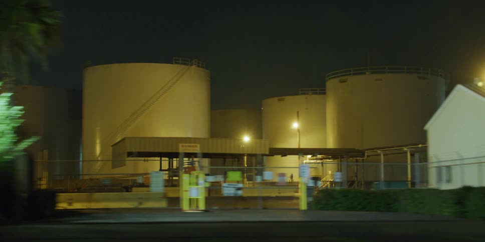 Driving near fuel containers inside an industrial complex at night