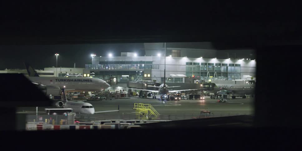 Airplanes at an airport terminal at night