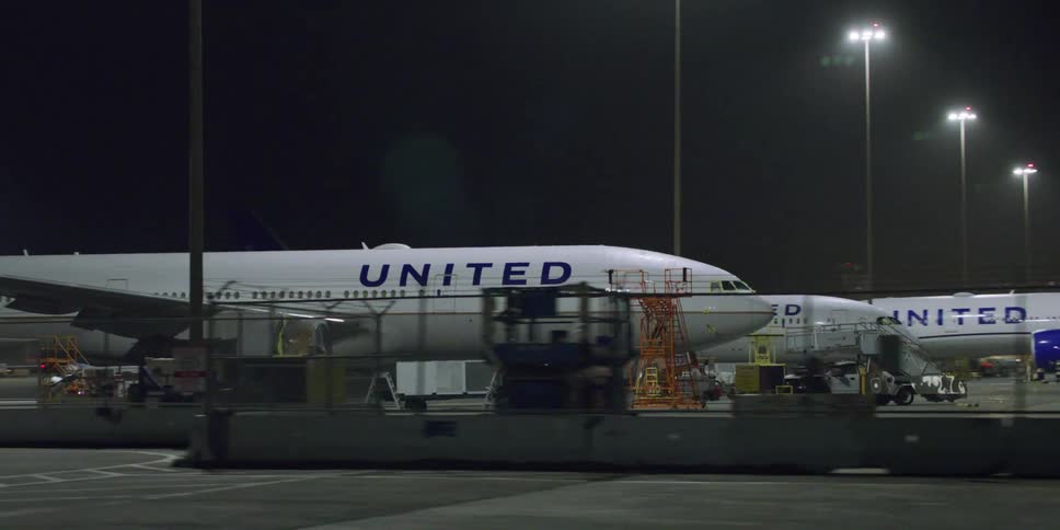 Driving near airline airplanes parked on an airport at night