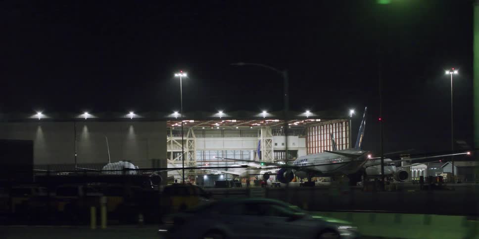 View of airports with planes seen from a moving car at night
