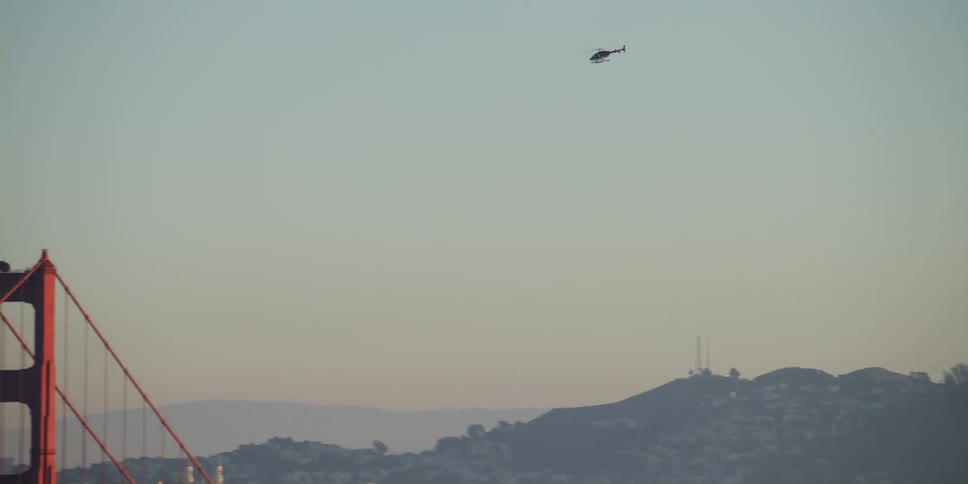 Aerial of helicopter flying across golden gate bridge on a hazy day