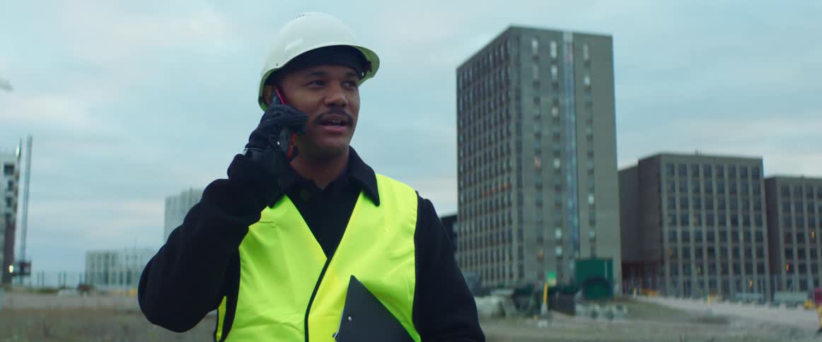 Project manager on a construction site talking on a cell phone
