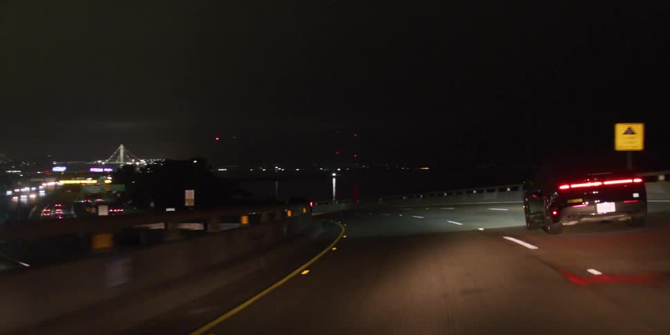 Cars driving in a highway towards a big city