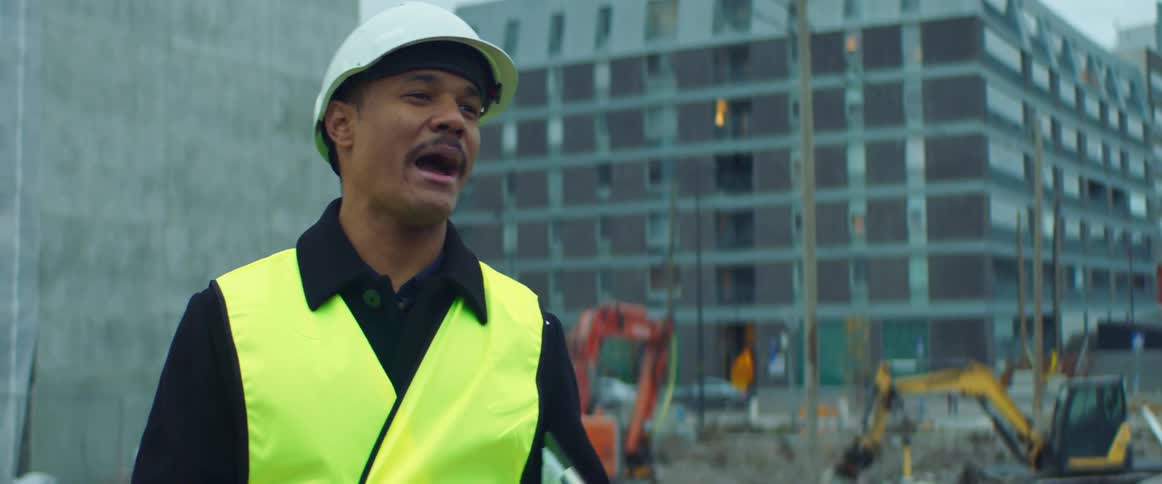 A construction worker is talking outdoors in a city