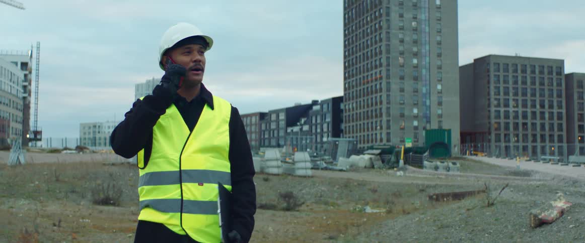 Project manger talking on a cell phone on a construction site