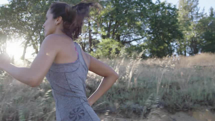 A woman jogging through a rural area