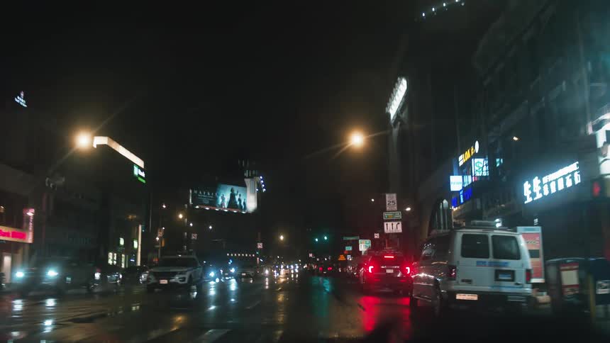 Cars are driving on a street through an urban city