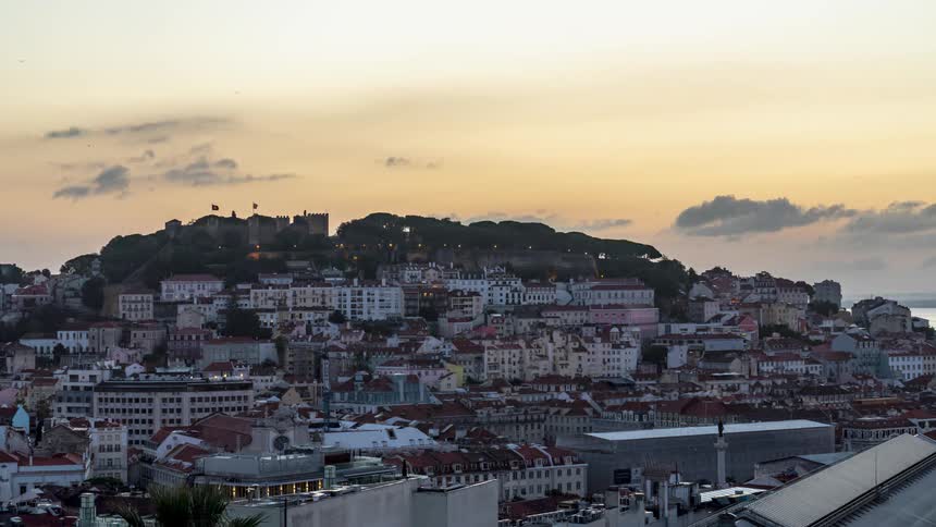 Time lapse of the sun rising over a small town